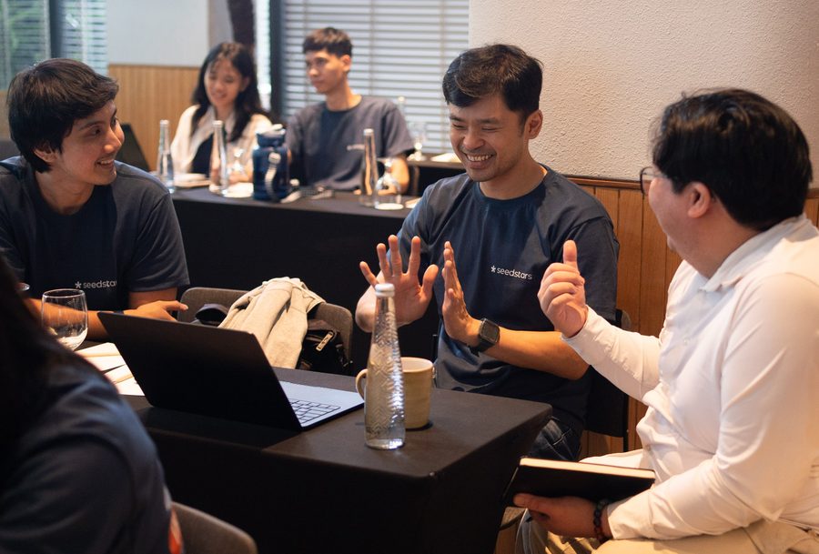 Founders in animated discussion at the bootcamp